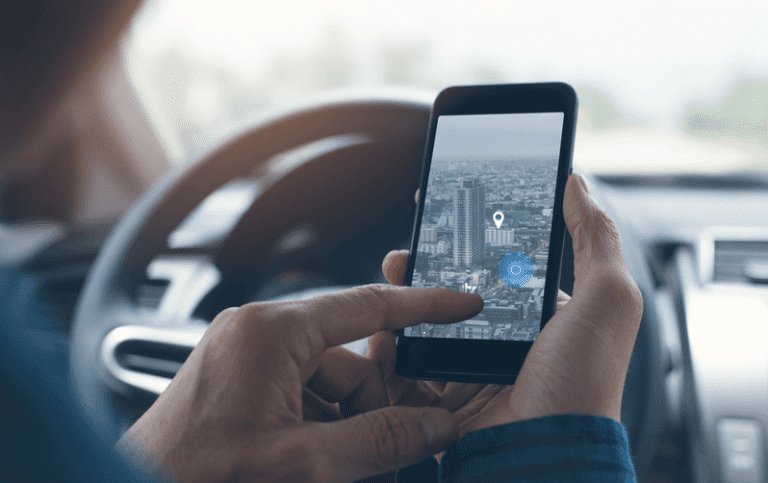 person using phone GPS in the car