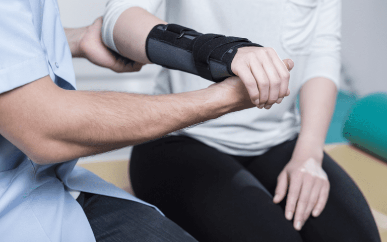 Woman using wrist immobilizer due to auto related injury