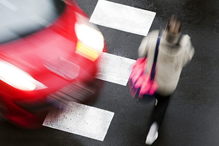 pedestrian using cross walk and almost hit by car