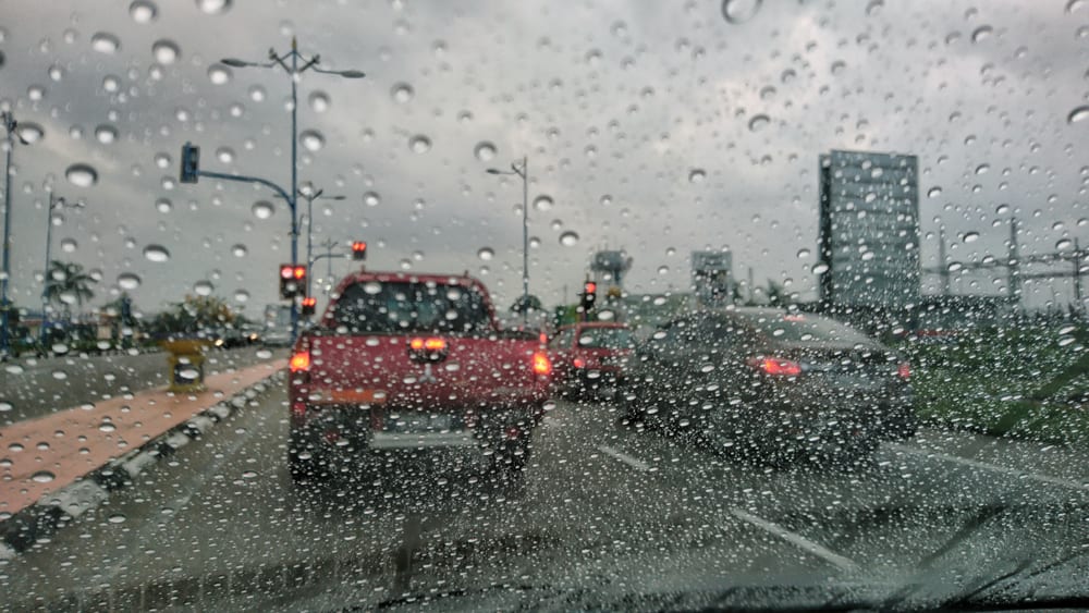 rain falling on cars on road