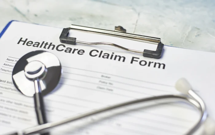 Healthcare claim form and stethoscope on clipboard, illustrating Louisiana medical liens on injury treatment and settlement costs.